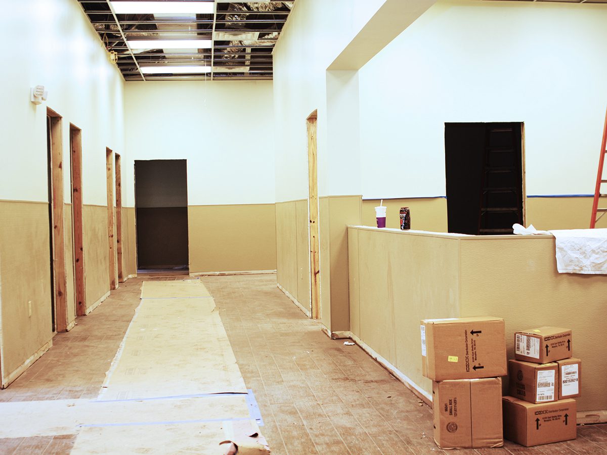 A hallway with boxes and walls in it